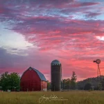 A little farm stands brightly against the colors of the sunset. Photo by Larry Holak